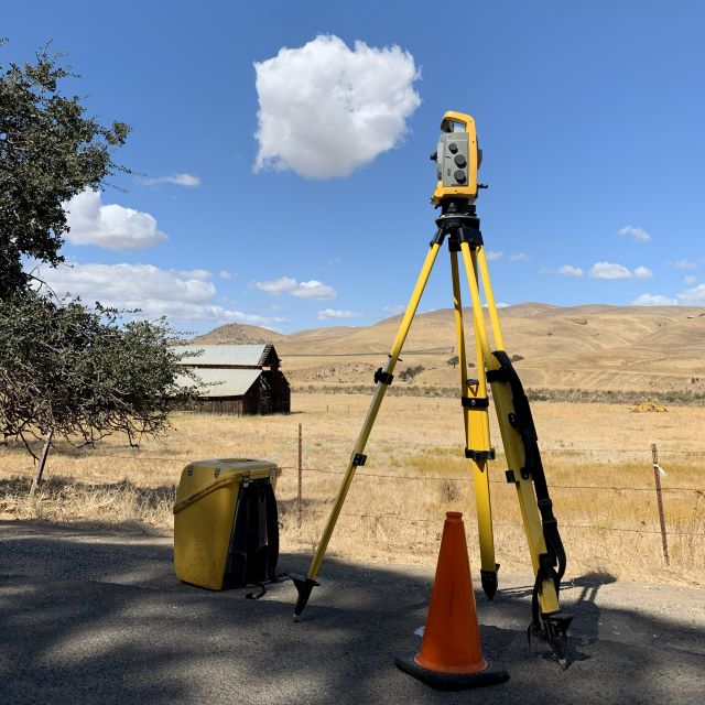 total station in a rural area doing boundary survey